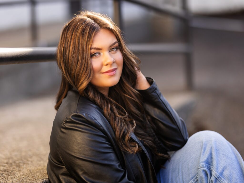 Senior portraits of a high school senior in Portland Oregon in a city setting with a leather jacket