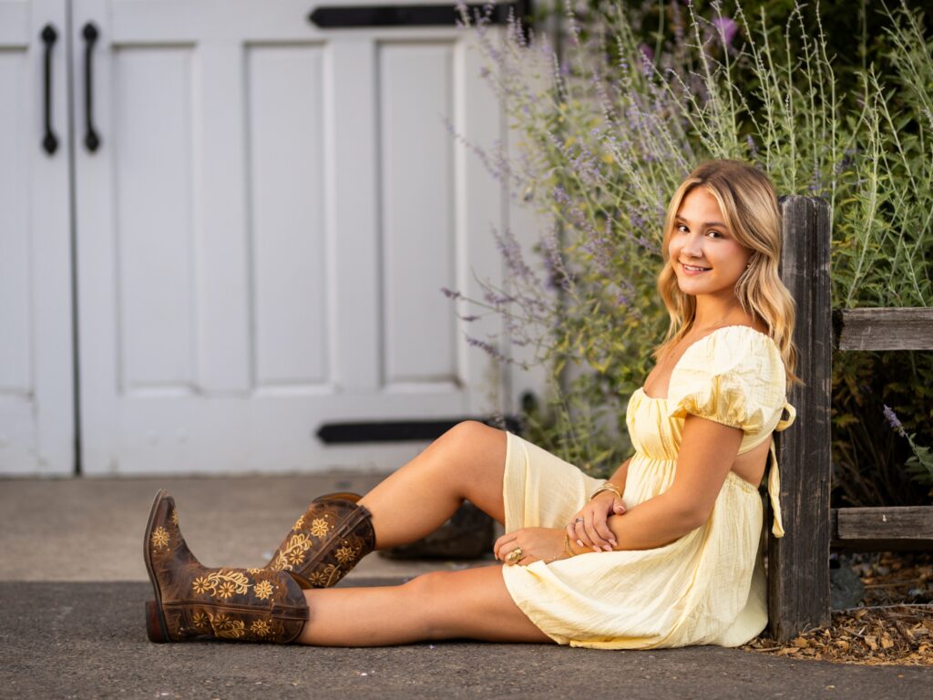 Girl senior photos in Vancouver Washington Lake Oswego, West Linn Oregon and Portland Oregon in the summer wearing a light yellow dress next to a white country barn
