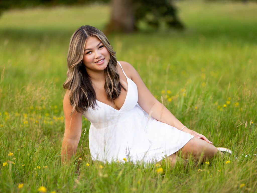Senior photos in Vancouver Washington and Portland Oregon in the summer in a tall grassy field with a girl in a dress