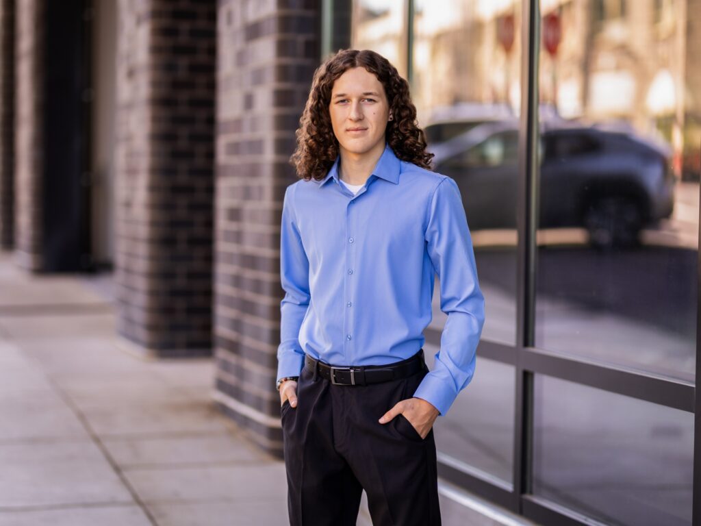 Guy senior portraits in Vancouver Washington by the waterfront with a blue button up shirt for a more business casual look