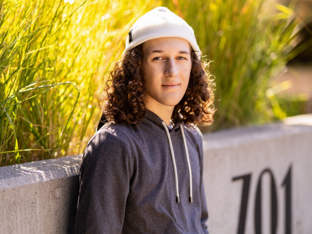 Guy senior portraits in Camas Washington in an urban setting in a gray sweatshirt and beanie
