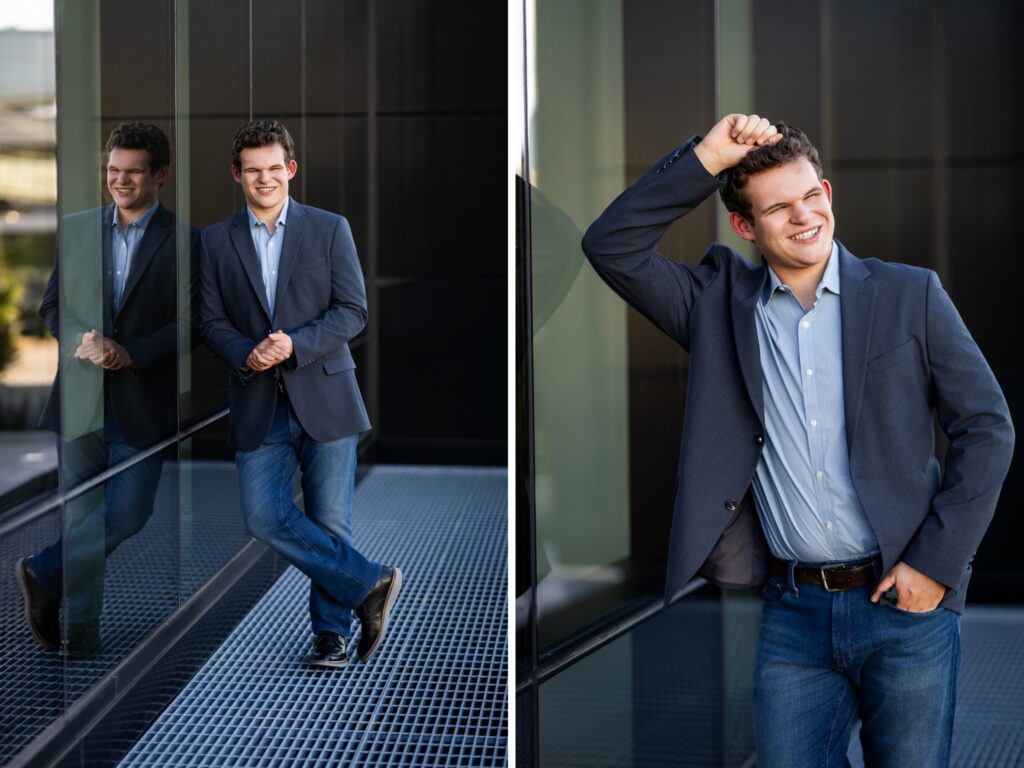 Guy senior photos in downtown Portland, OR wearing a gray sport coat, light blue button-up shirt, and jeans with modern glass architecture.