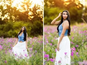 Girl senior photos in a purple sweet pea flower field wearing a denim top and white skirt at golden hour.