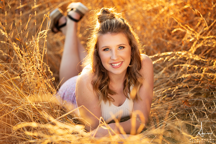 Nature and urban senior photos in Vancouver Washington and Ridgefield Washington in a field during golden hour