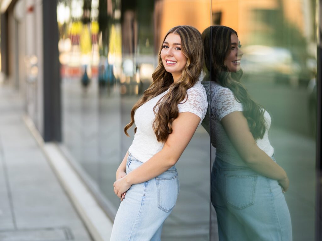 Girl senior photos in downtown Portland Oregon in the city in the summer in a casual jeans outfit in an urban environment
